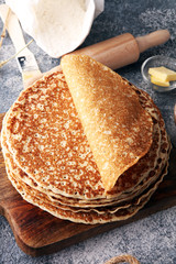 French crepes or pancakes with ingredient on grey background