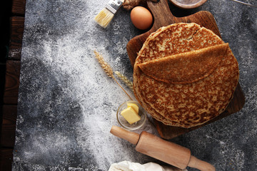 Fototapeta na wymiar French crepes or pancakes with ingredient on grey background
