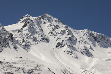 Fototapeta na wymiar Snow-covered, fresh white mountain peak in the Alps of Switzerland