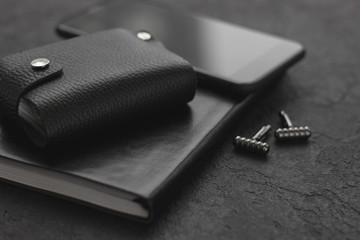 Black style Man set: notepad, phone and cufflinks. Black background