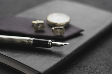 Black style Man set: notepad, pen and cufflinks. Black background