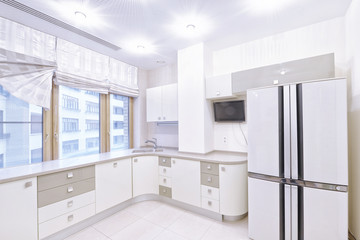 Modern design white kitchen in a spacious apartment.
