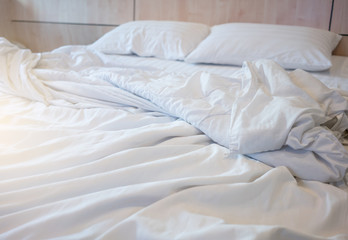 Fototapeta na wymiar White themed bed sheets bedroom interior.