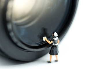 Miniature people : Maid cleaning camera lens.