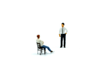 Miniature people : Man sitting a chair with businessman.