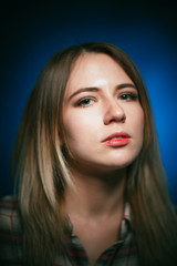 Fototapeta premium portrait smiling girl on blue background in studio