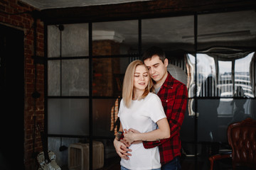 stylish young couple having fun in cozy bedroom in style loft,  feeling happy being together.