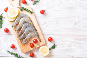 fresh shrimps or prawns raw on wooden board