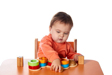Child little girl learning to use colorful logic game isolated on white background
