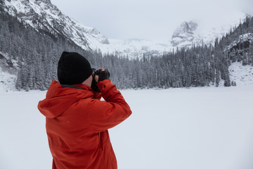 Fototapeta na wymiar Photographer taking pictures in Joffre Lakes, British Columbia, Canada.