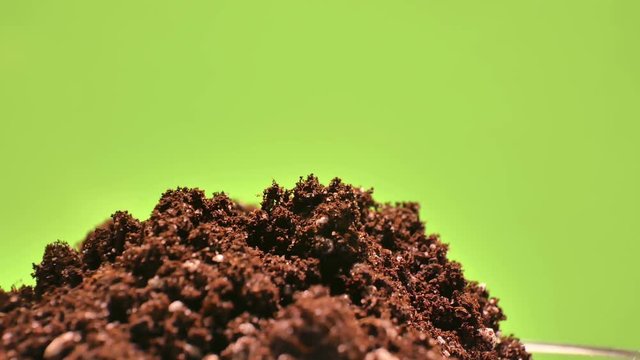 Soil close-up, laboratory research. A pipette with a solution. The soil rotates smoothly on a green background. Keying ready.