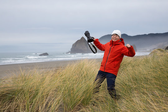 Photographer taking picture in the beautiful Oregon Coast during a winter morning.