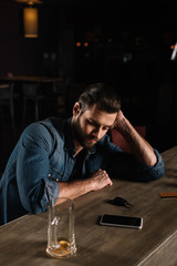 Obraz premium tired visitor sitting at bar counter in evening