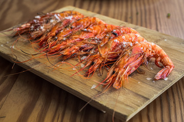 Grilled shrimps on a wooden plate