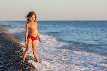 The girl stand one on the seashore