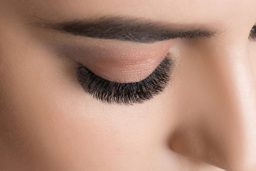 Closeup image of beautiful woman eye with fashion makeup and long eyelashes