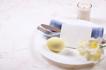 Easter laying table appointments, table setting options. Silverware, tableware items with festive decoration. Fork, knife and flowers. Happy easter holiday.