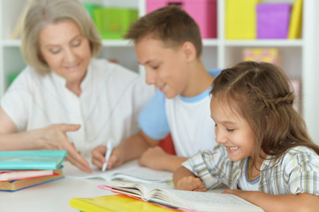 Fototapeta na wymiar granny with grandchildren doing homework
