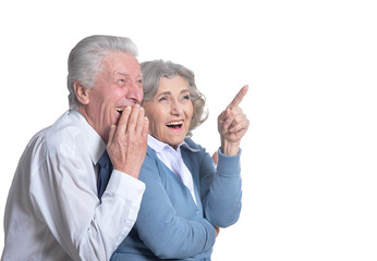 hugging senior couple pointing isolated