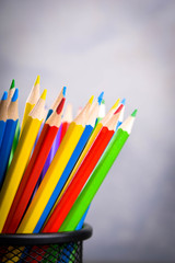 Pencils colorul color wooden pencil in metal holder in front of wall background