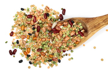 Mixed dried legumes and cereals with wooden spoon isolated on white background