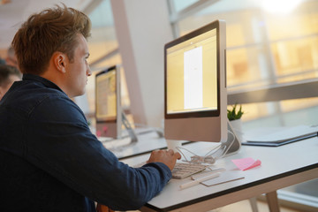 Student in class working on desktop computer