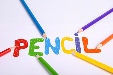 Colorful pencils isolated on white background. Top view with colored pencil caption. With copy space