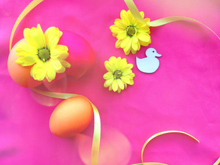 Easter concept. Easter bright background: yellow spring flowers, colorful eggs and multicolored sprinkles