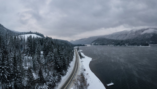 Striking aerial panoramic Canadian Mountain Landscape during a winter morning. Taken at Mara Lake near Sicamous, British Columbia, Canada.