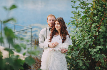 stylish bride and groom posing on the background of the river