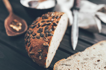 Delicious fresh bread on wooden background