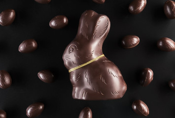 Chocolate Easter bunny and eggs on dark background