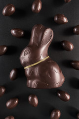 Chocolate Easter bunny and eggs on dark background