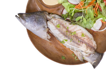 A teamed fish on the wooden plate