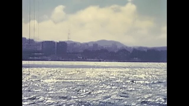 Alcatraz island in San Francisco Bay skyline. Sea view from boat touristic tour. Archival San Francisco restored footage in California, United States in 1980.