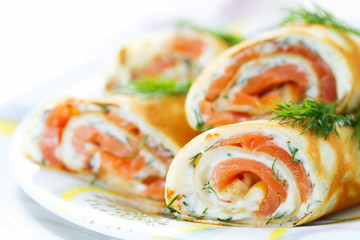 Pancakes with fish salmon, cheese and dill. Macro. Space for text
