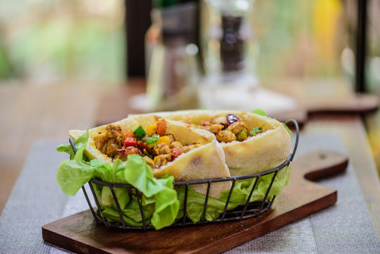 Pork and Chicken Curry Roti naan bread wraps at indian food restaurant.