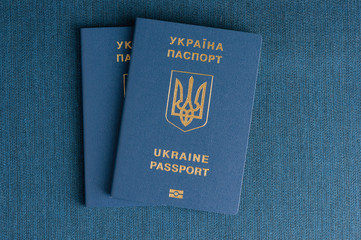Several Ukrainian passports on a blue background.