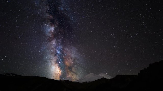 Beautiful night landscape.
The Milky Way galaxy is moving over the Caucasian mountain range, above the volcano Elbrus. The highest mountain peak in Europe. 4k