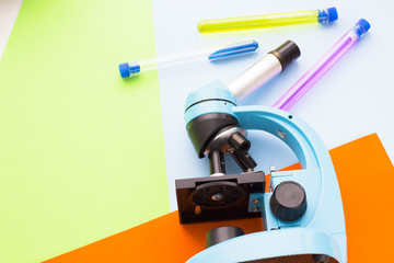 Chemistry class makes chemistry experiment. STEM. Robotics, mechanic, chemistry, biology. Modern education. Fun and interesting. Colorful paper background Top view