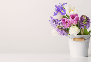 spring flowers in bucket on white  background