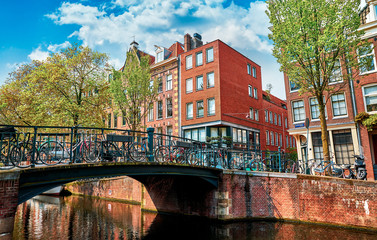 Naklejka premium Bridge over channel in Amsterdam Netherlands houses river Amstel