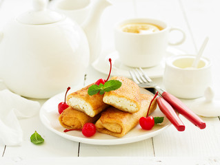 Russian crepes stuffed with curd and cherry.