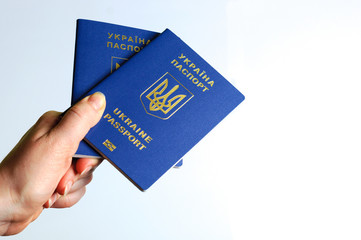 Blue Ukrainian passport in the a woman hands . Isolate