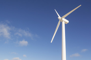 Wind turbines generating electricity with blue sky - energy conservation concept
