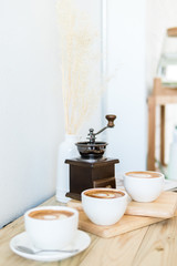 coffee cup on old wood table,coffee lover background concept,selective focus on single coffee grinder.