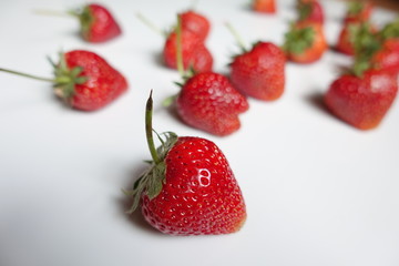 group of strawberries on the floor, red fruit, plant in countryside farm, feel fresh and sweet, fruit macro photography concept