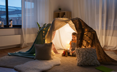 little girl with toys in kids tent at home © Syda Productions