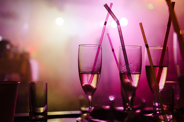 A party in a nightclub, champagne glasses with straws