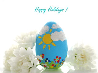 Easter egg with ribbon and flowers on white background